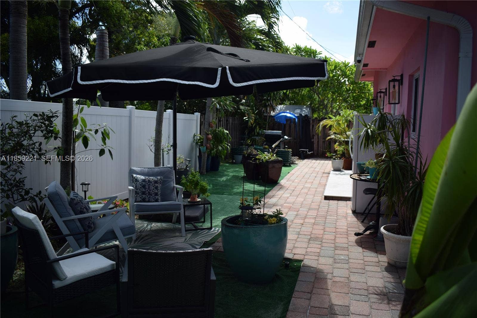 524 NE 27th Drive, Wilton Manors, FL 33334 Generous rear patio features versatile spaces perfect for lounging, dining, or entertaining in comfort