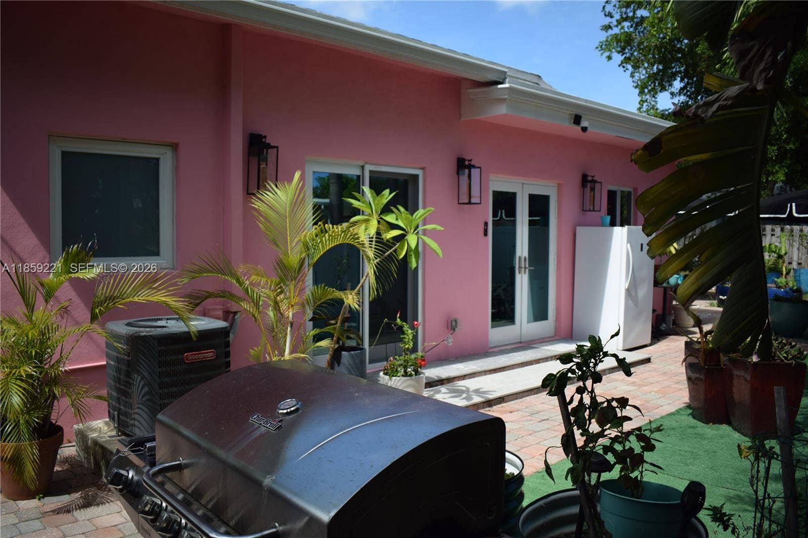 524 NE 27th Drive, Wilton Manors, FL 33334 Generous rear patio features versatile spaces perfect for lounging, dining, or entertaining in comfort