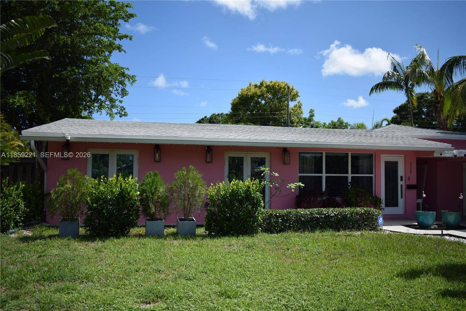 524 NE 27th Drive, Wilton Manors, FL 33334 Enjoy a spacious, clean approach through the private garden, offering a graceful transition to the front door
