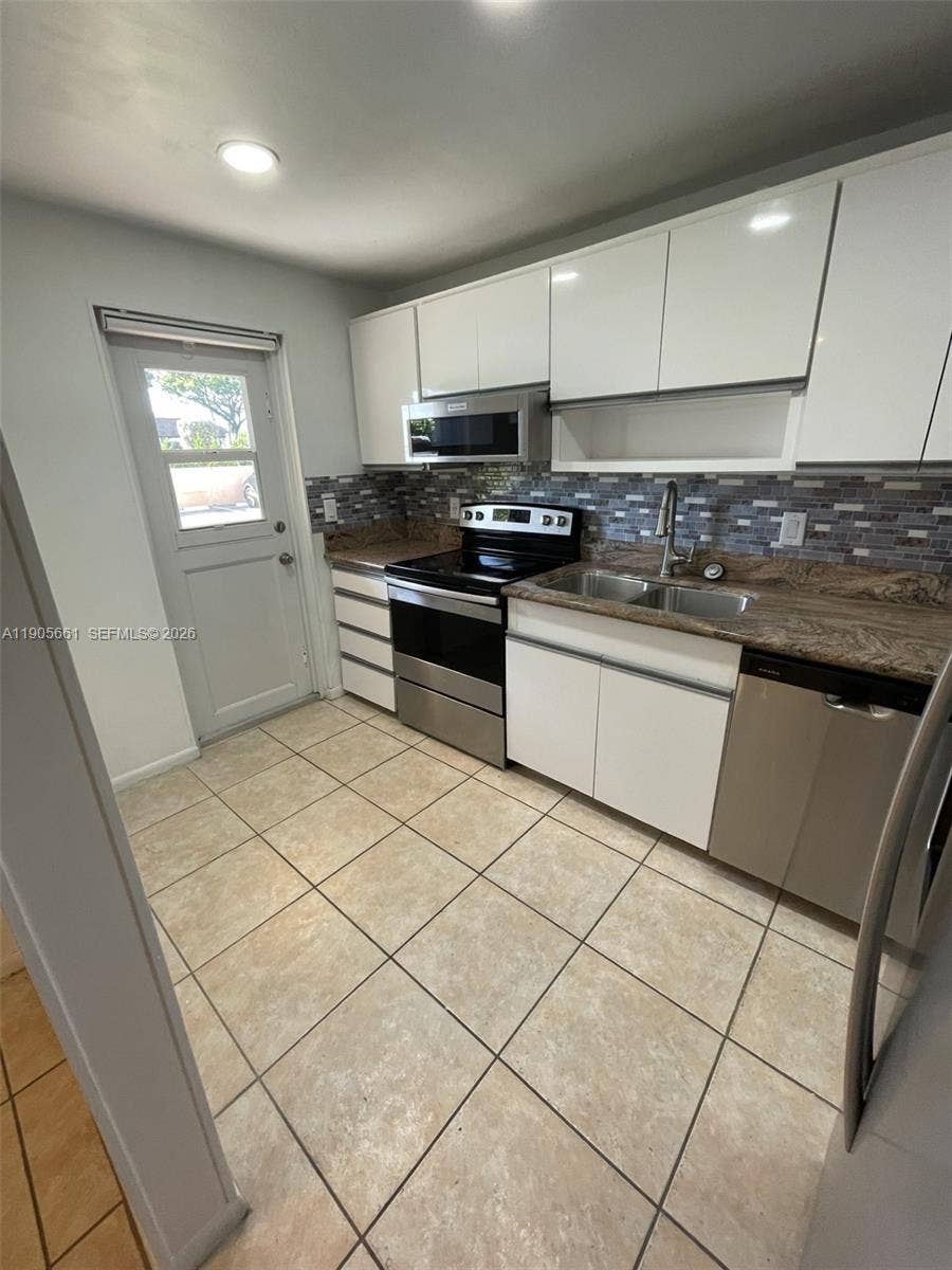 Kitchen with New Stainless Steel Appliances and Recessed Ceiling Lights