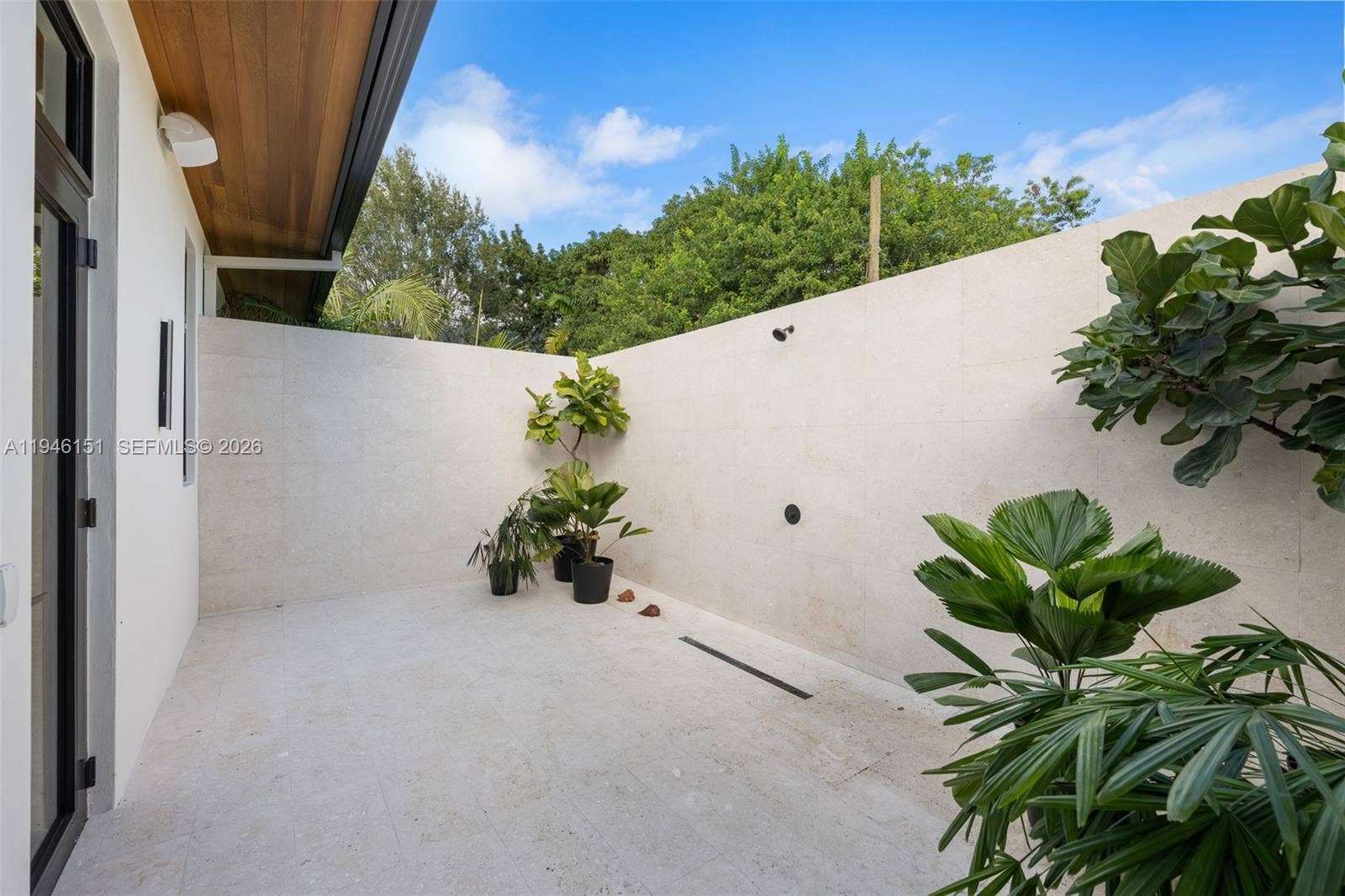 7725 SW 114th Street, Pinecrest, FL 33156 Exterior Shower & Tanning Area with Privacy Wall located in Primary Bedroom