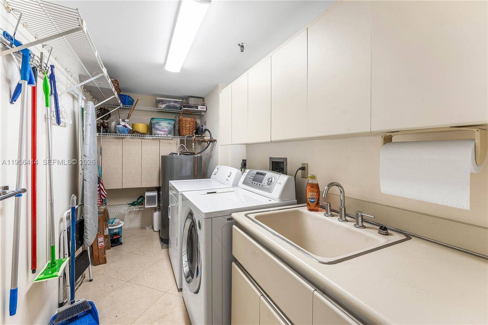 Large laundry room with sink and extra storage