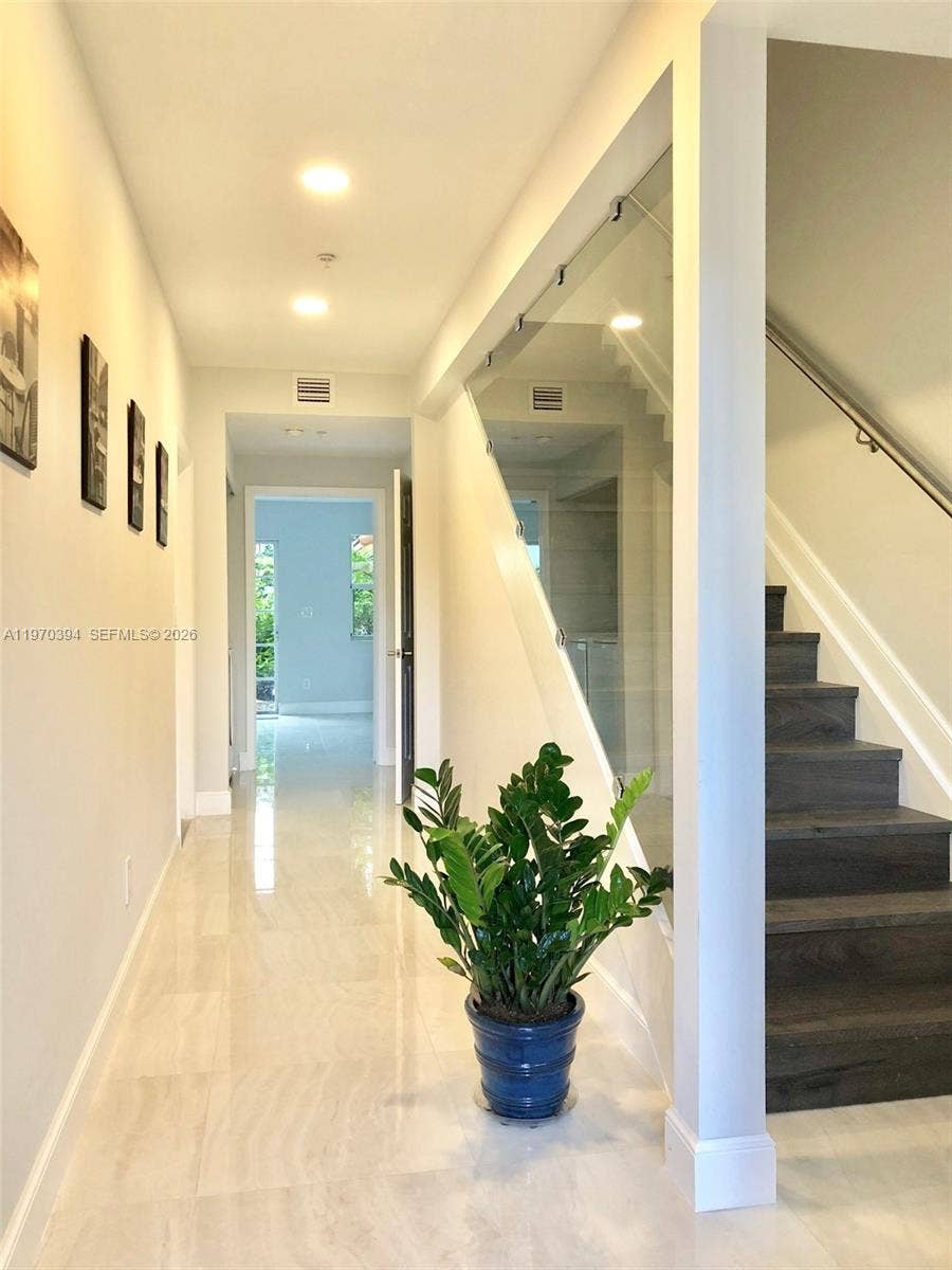 621 NE 8th Avenue, Fort Lauderdale, Fort Lauderdale, FL 33304 Kronoswiss engineered wood stairs with glass & SS rails