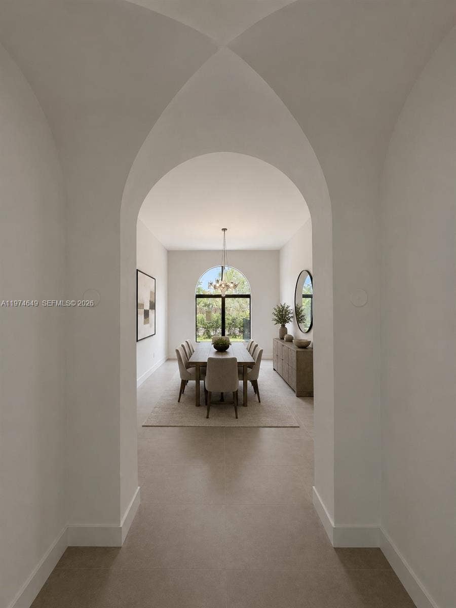 Art passage way from great room to dining room. AI Staged.