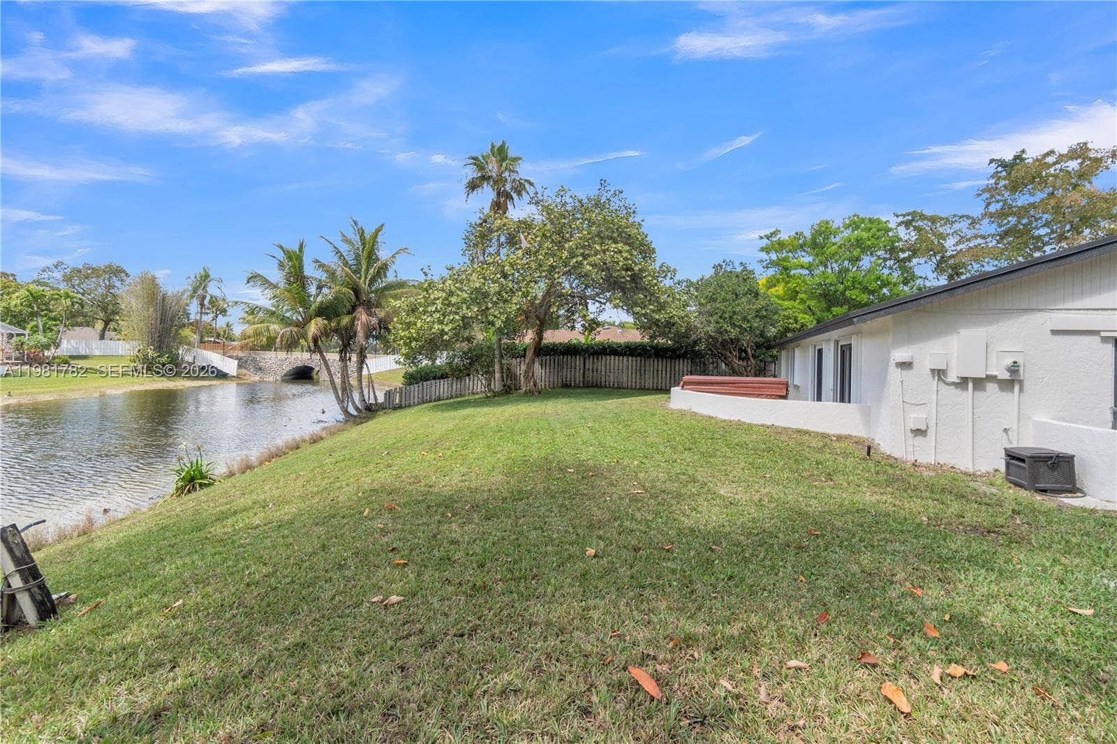 Large backyard with direct access to the lake & will easily accomodate a pool