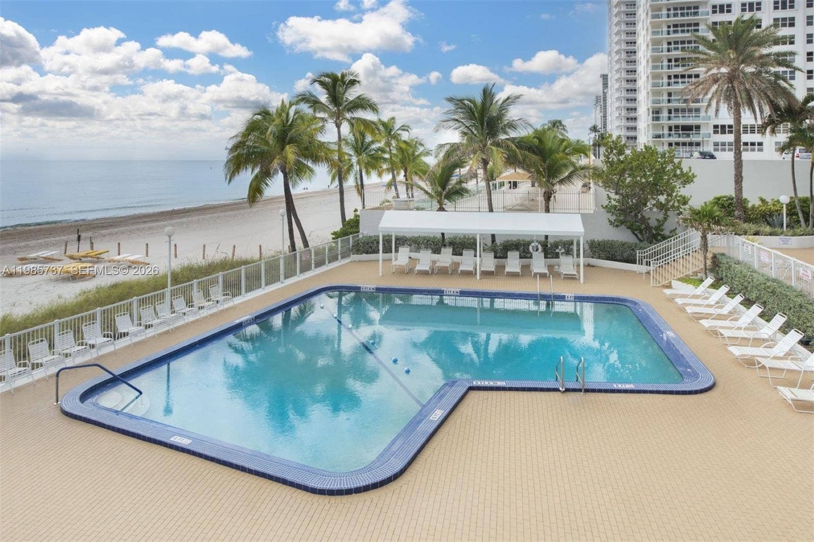 Pool located next to beach/ocean