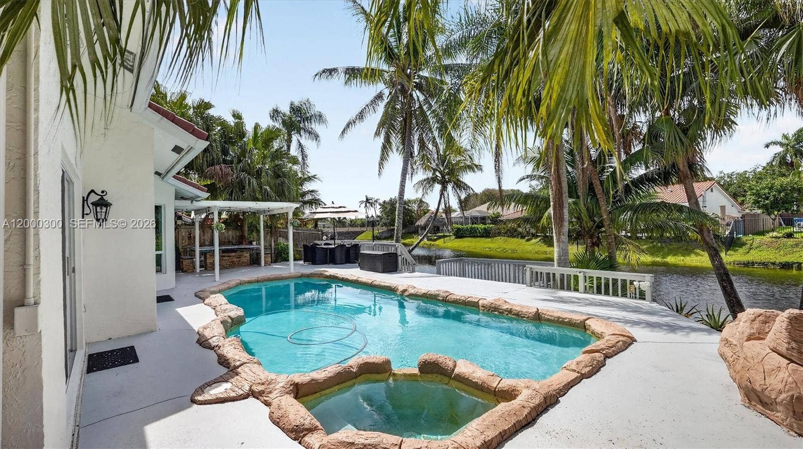 11620 S Budd Drive, Cooper City, FL 33026 Pool, deck, lake, palm trees