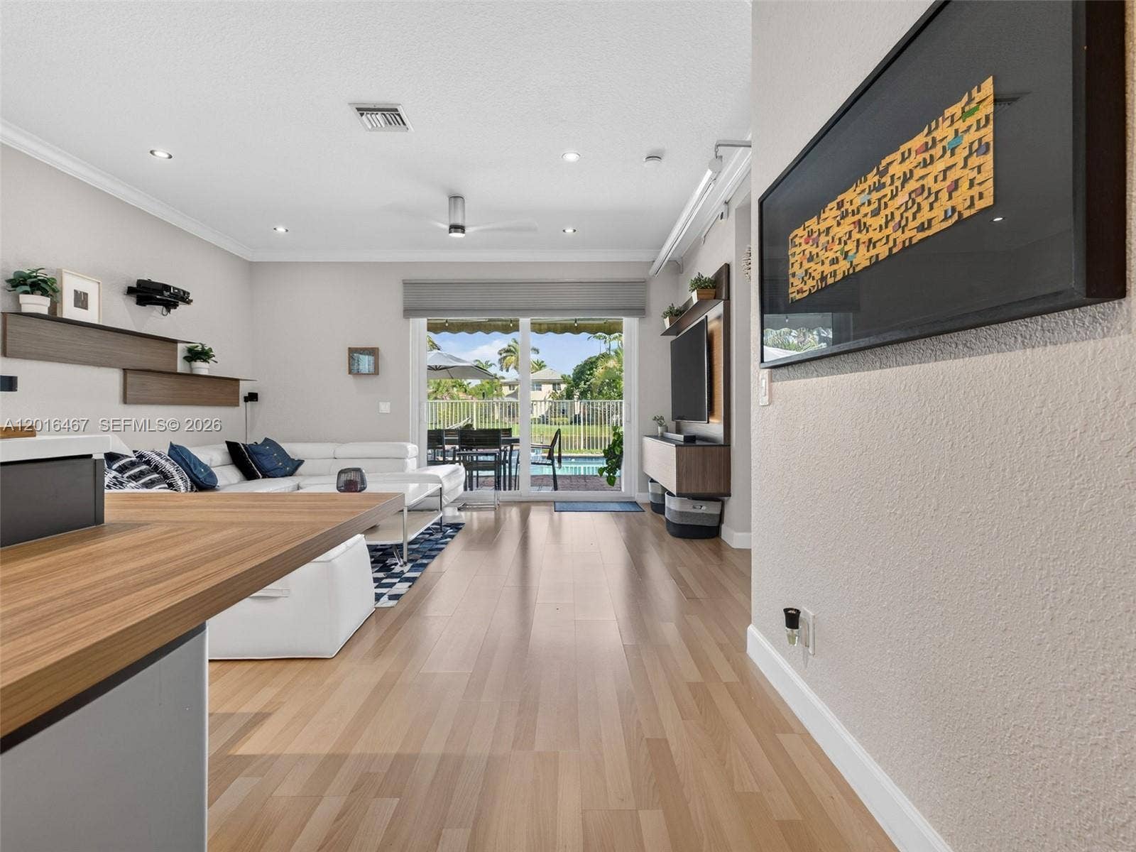 Kitchen area overlooking the family room, with pool/lake views.