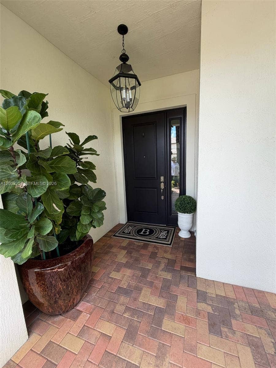 FRONT DOOR WITH COVERED ENTRY WAY.