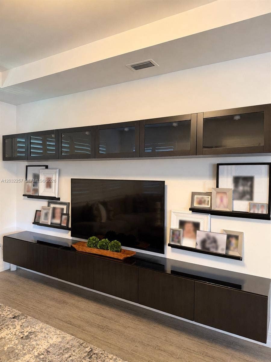 LOFT HAS A FLOATING TV / STORAGE UNIT