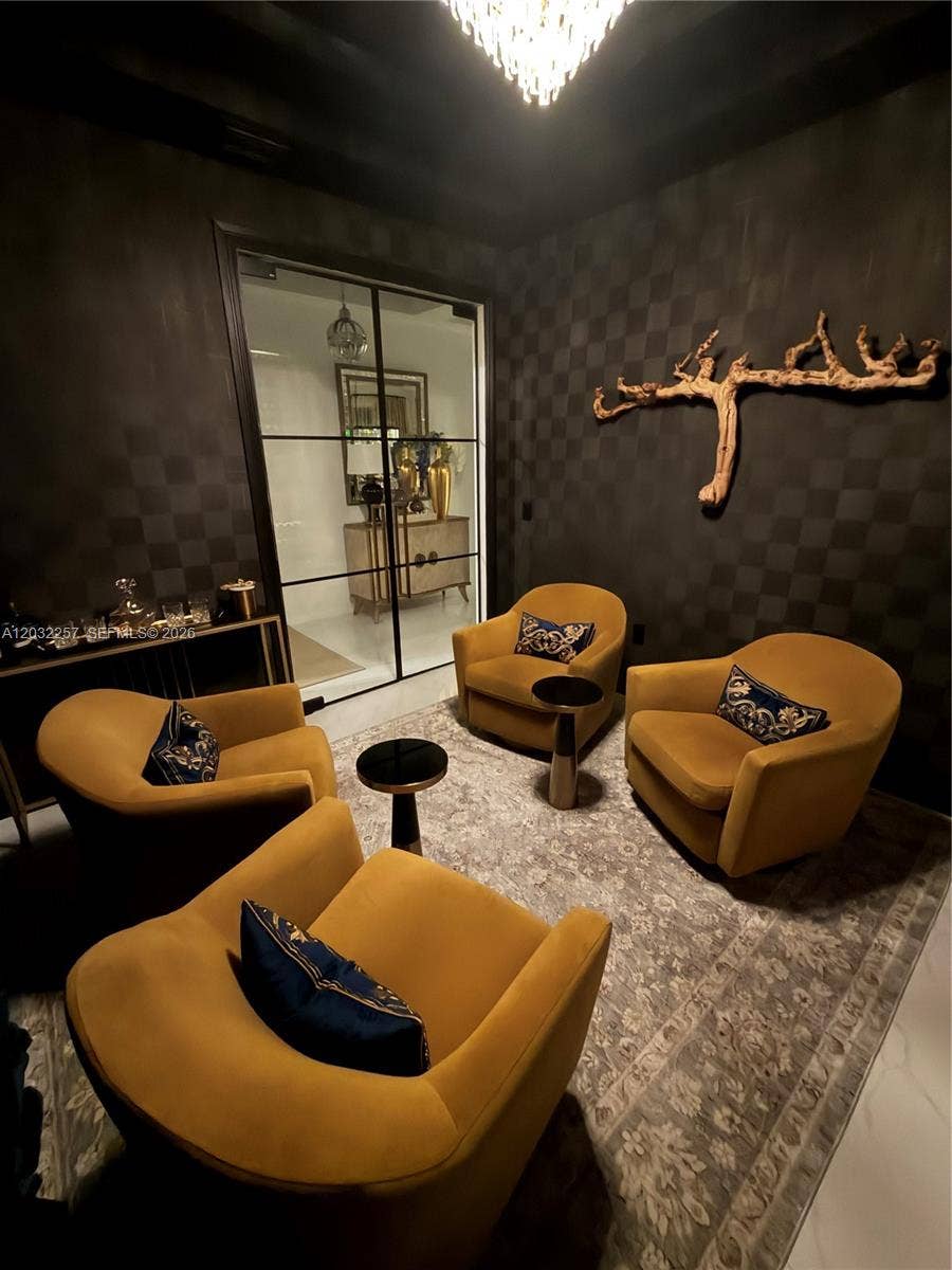 WINE CELLAR IS WRAPPED IN A RICH, DARK DESIGNER WALLPAPER CREATING A WARM AND INTIMATE SPACE.