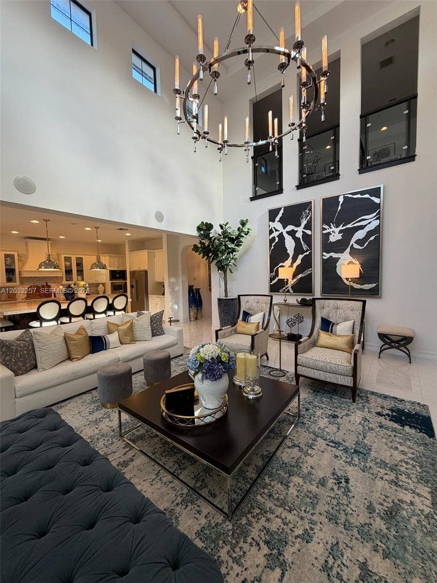 GREAT ROOM WITH SOARING 22' CEILING, BEAUTIFUL TRAY CEILING DECORATED WITH 6' DESIGNER CHANDELIER.