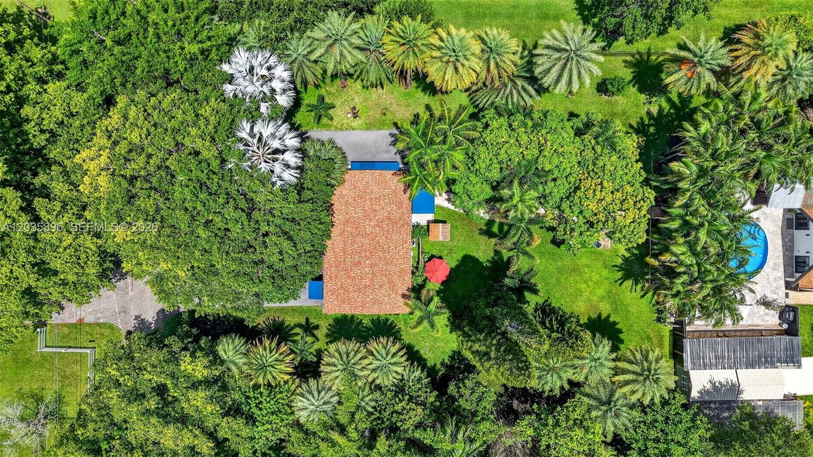 Grounds. Main house on right and guest house on left in mature garden setting