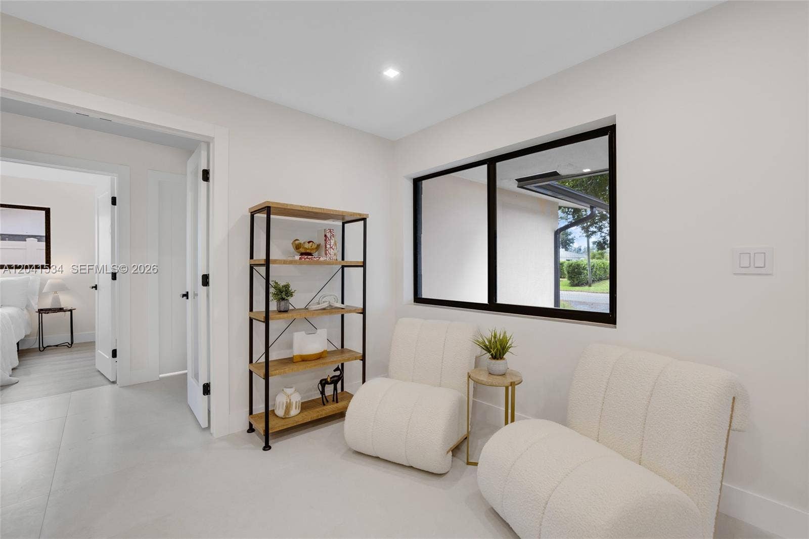 Additional sitting area with natural light and modern finishes.