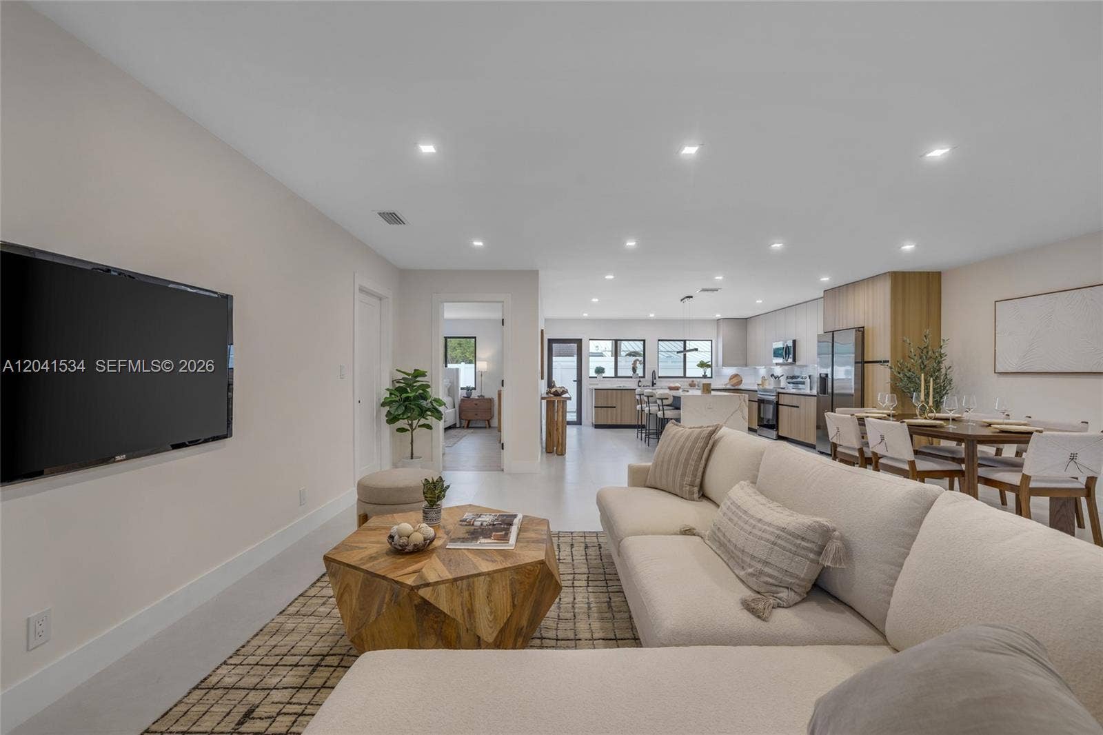 Open concept living area connecting to the kitchen and dining spaces.