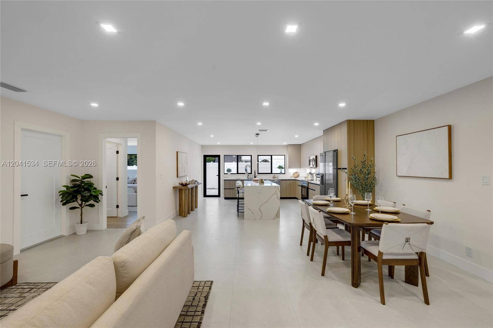 Living and dining spaces connected by a spacious open floor plan.