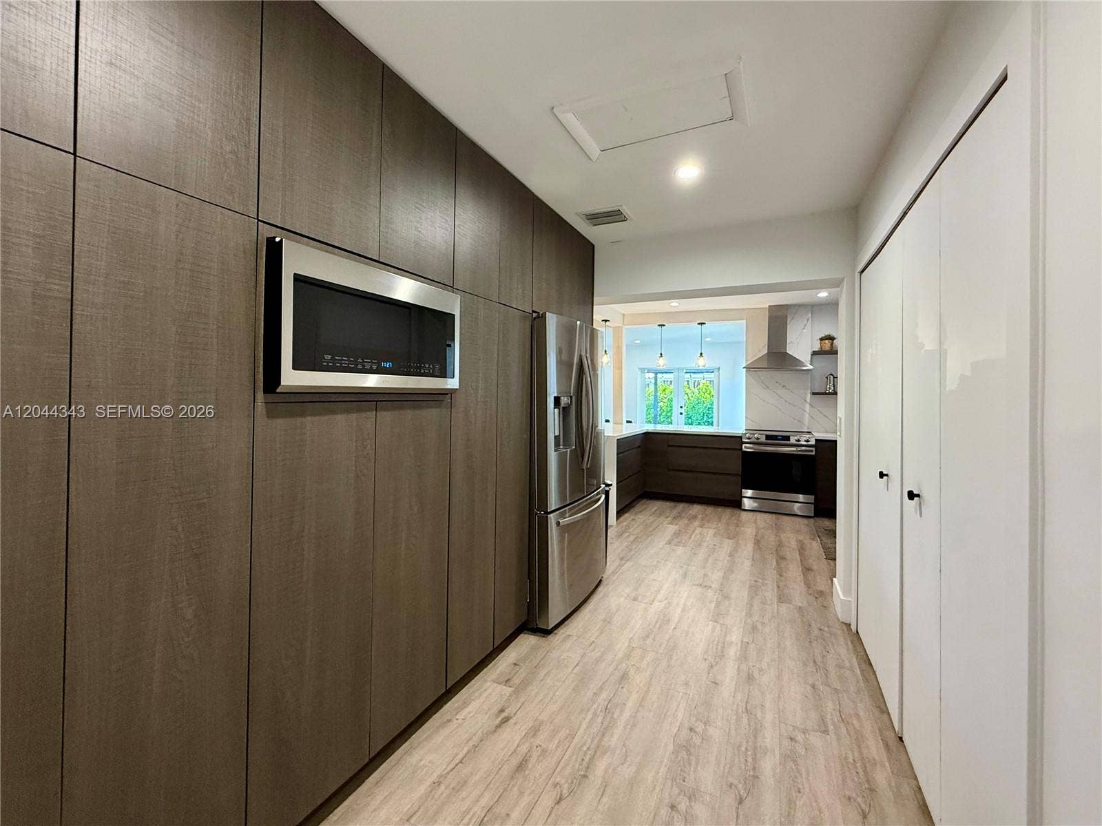 Microwave, pantry and laundry area