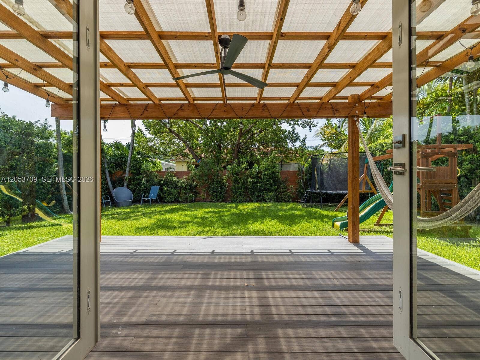 9033 Carlyle Avenue, Surfside, FL 33154 French Doors from Florida Room to Pergola-covered Back Deck