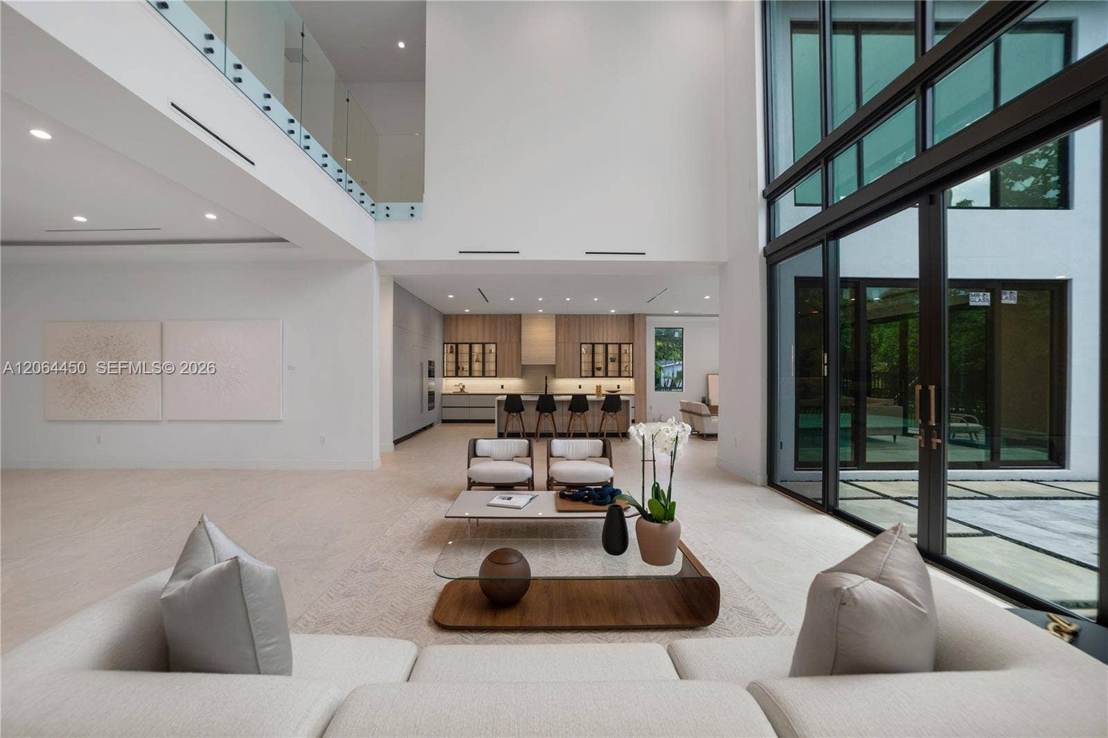 Living area bathed in natural light from full height impact glass