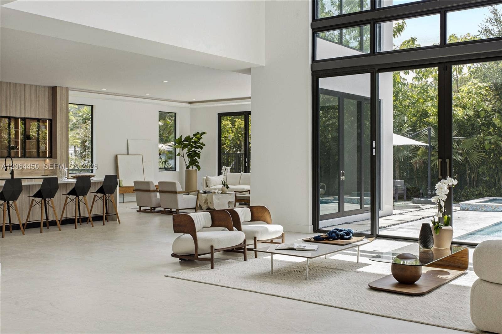 Open plan living area with direct sightlines to the kitchen and outdoor spaces