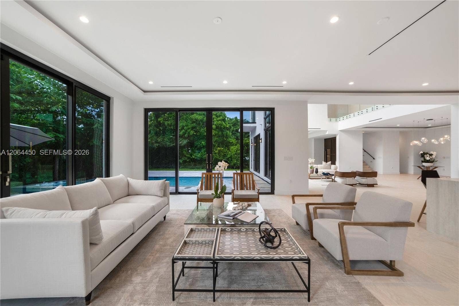Family room with floor to ceiling windows and views of lush greenery