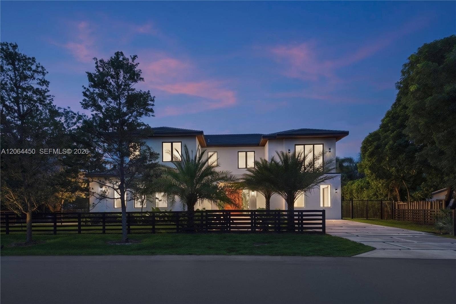 Front of the home at twilight with dramatic sky and landscape lighting