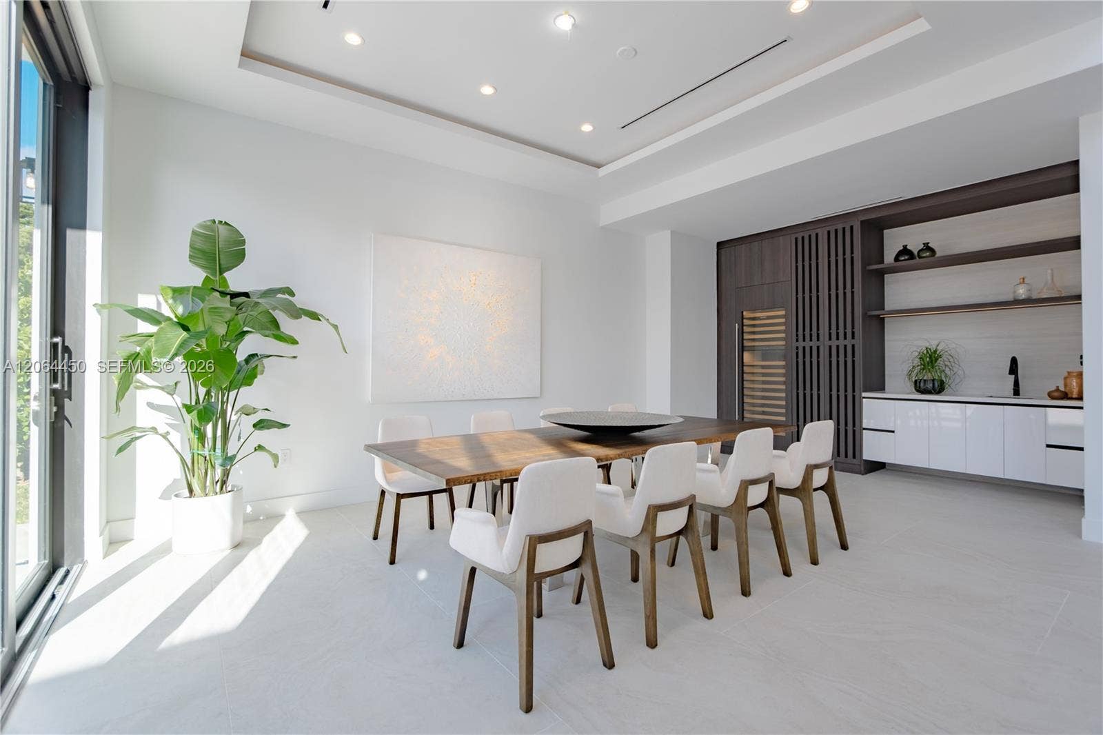 Dining space with seating for ten, set beneath a sleek coffered ceiling