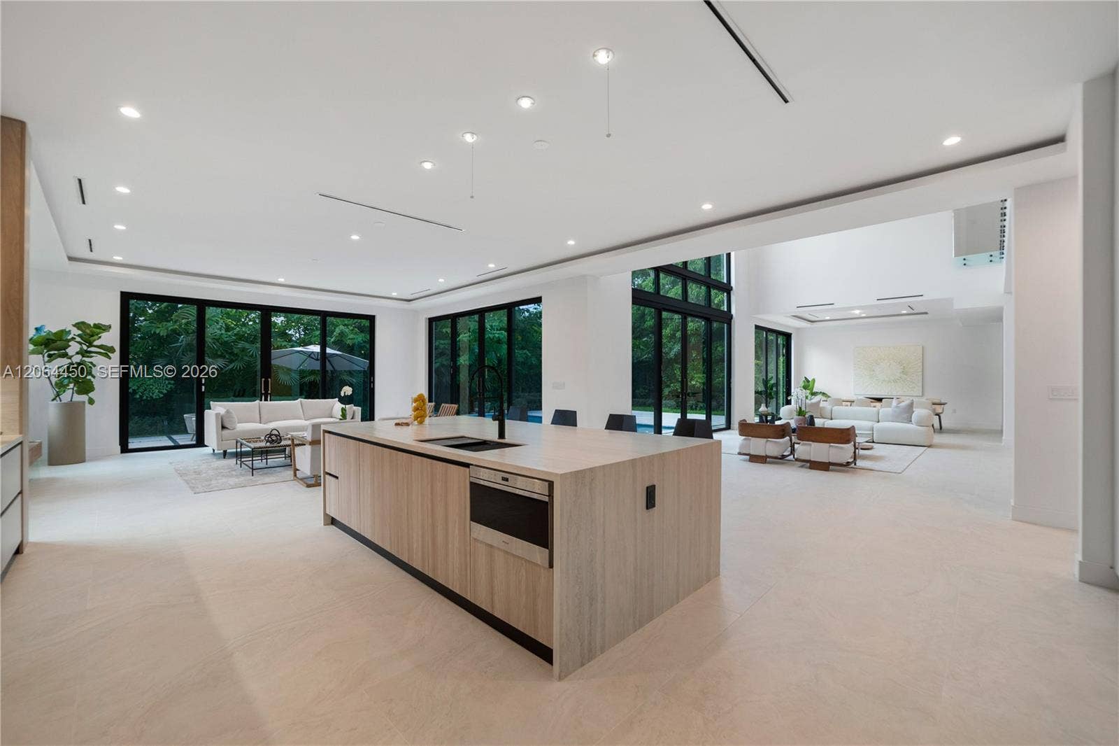 Kitchen island overlooking the family room and walls of glass