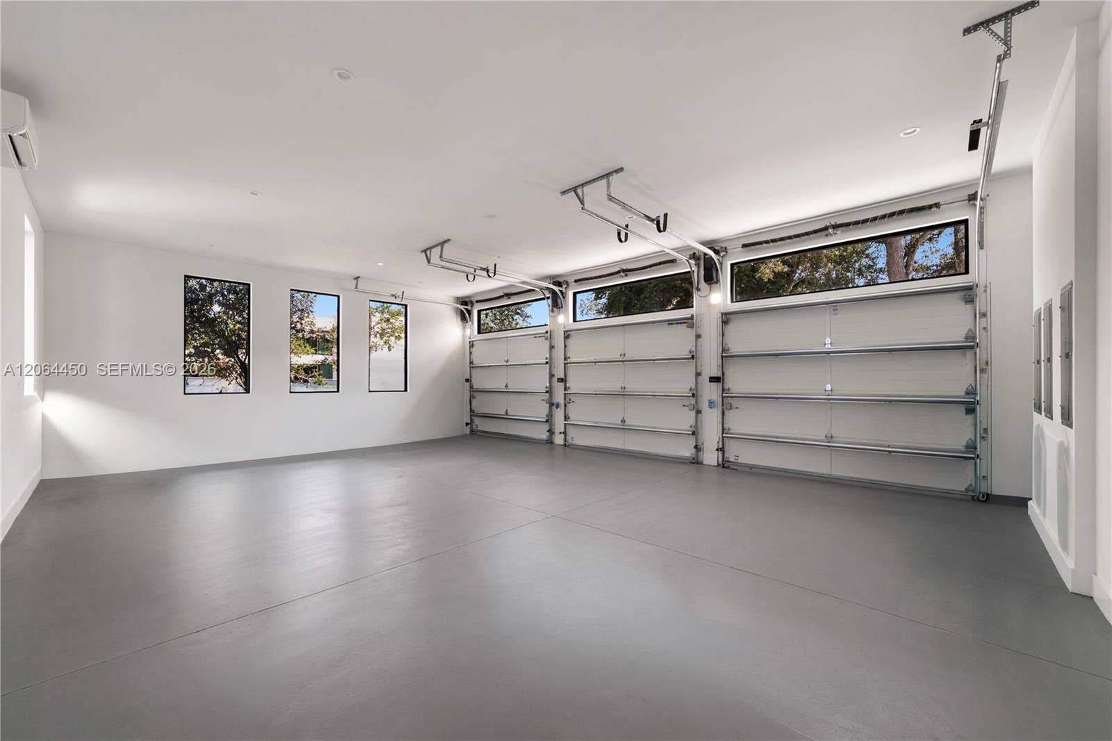 Oversized garage with epoxy floors and ample room for vehicles and storage