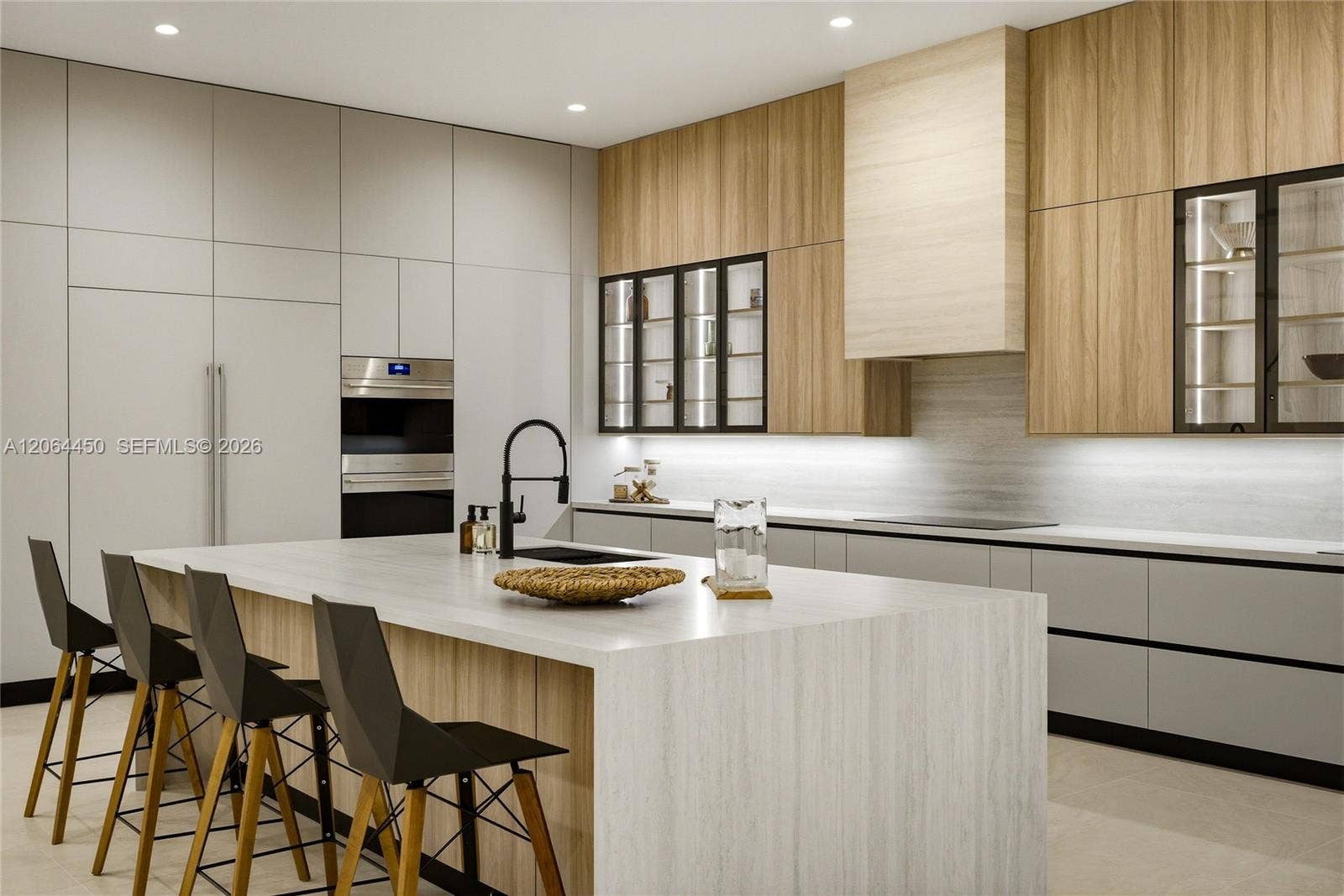 Chef's kitchen with custom wood and lacquer cabinetry and a large island
