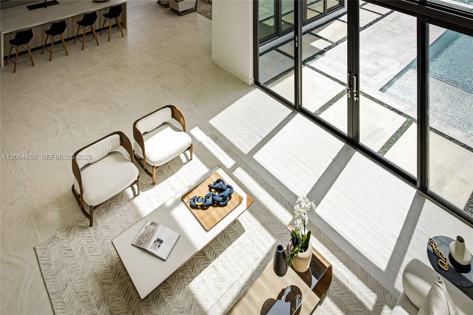 Elevated view of the living area highlighting the scale of the glass walls