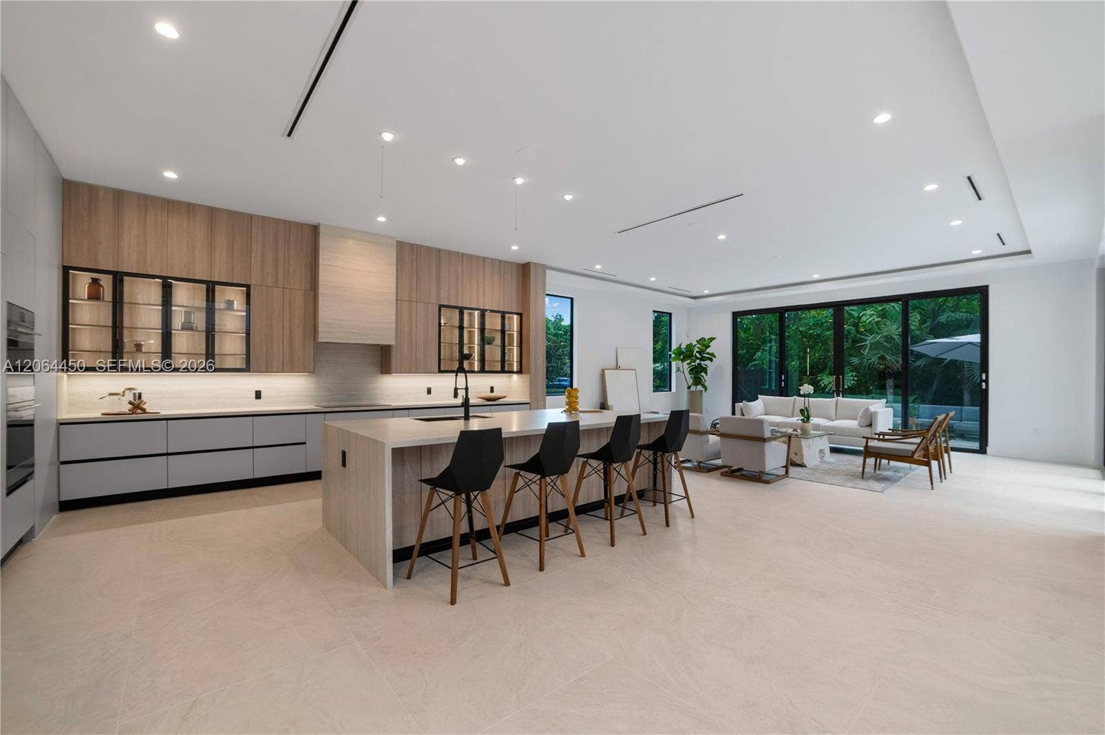 Open kitchen with generous island seating and views to the backyard