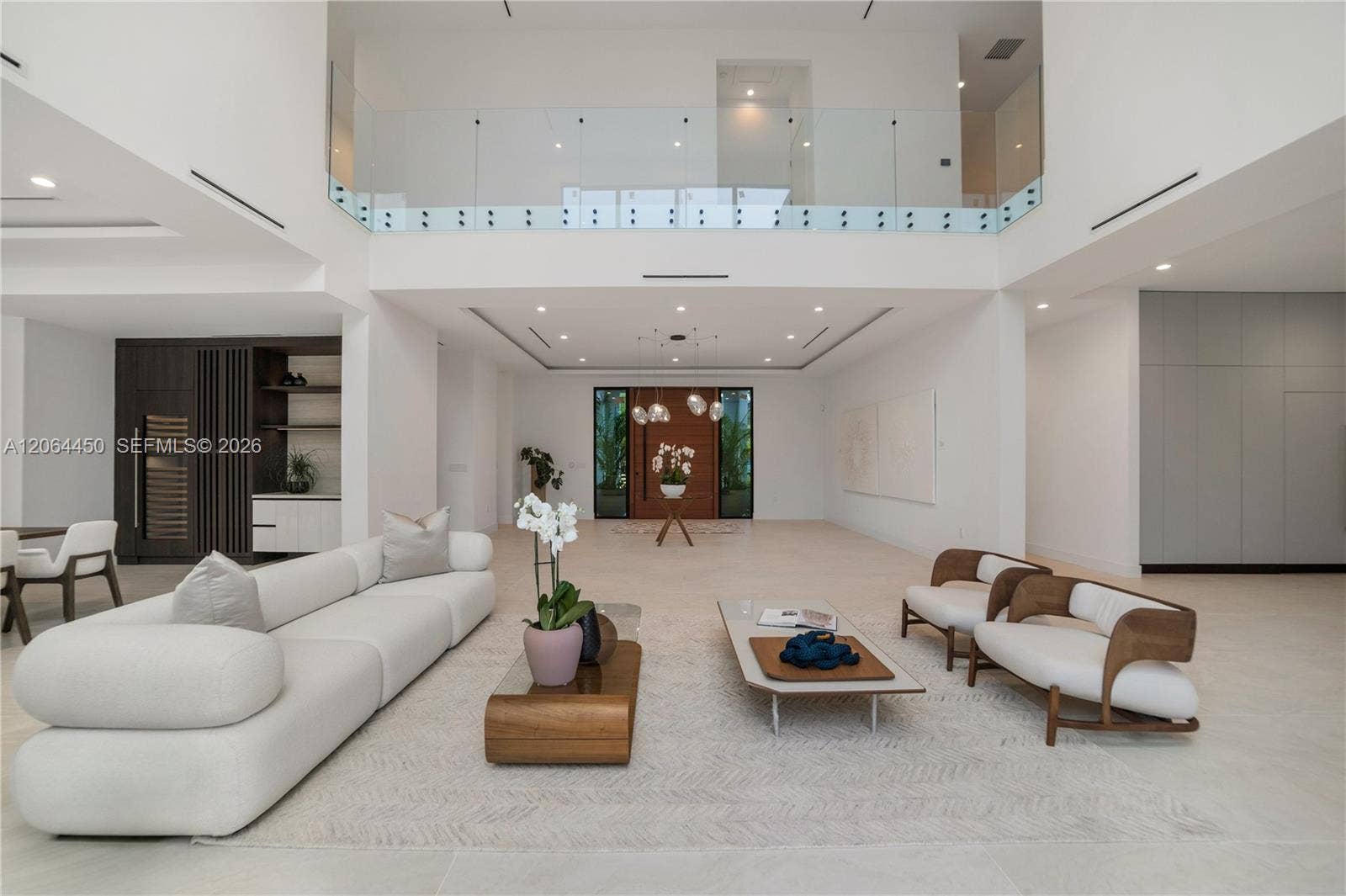 Expansive double height living area with the floating staircase and overlook above