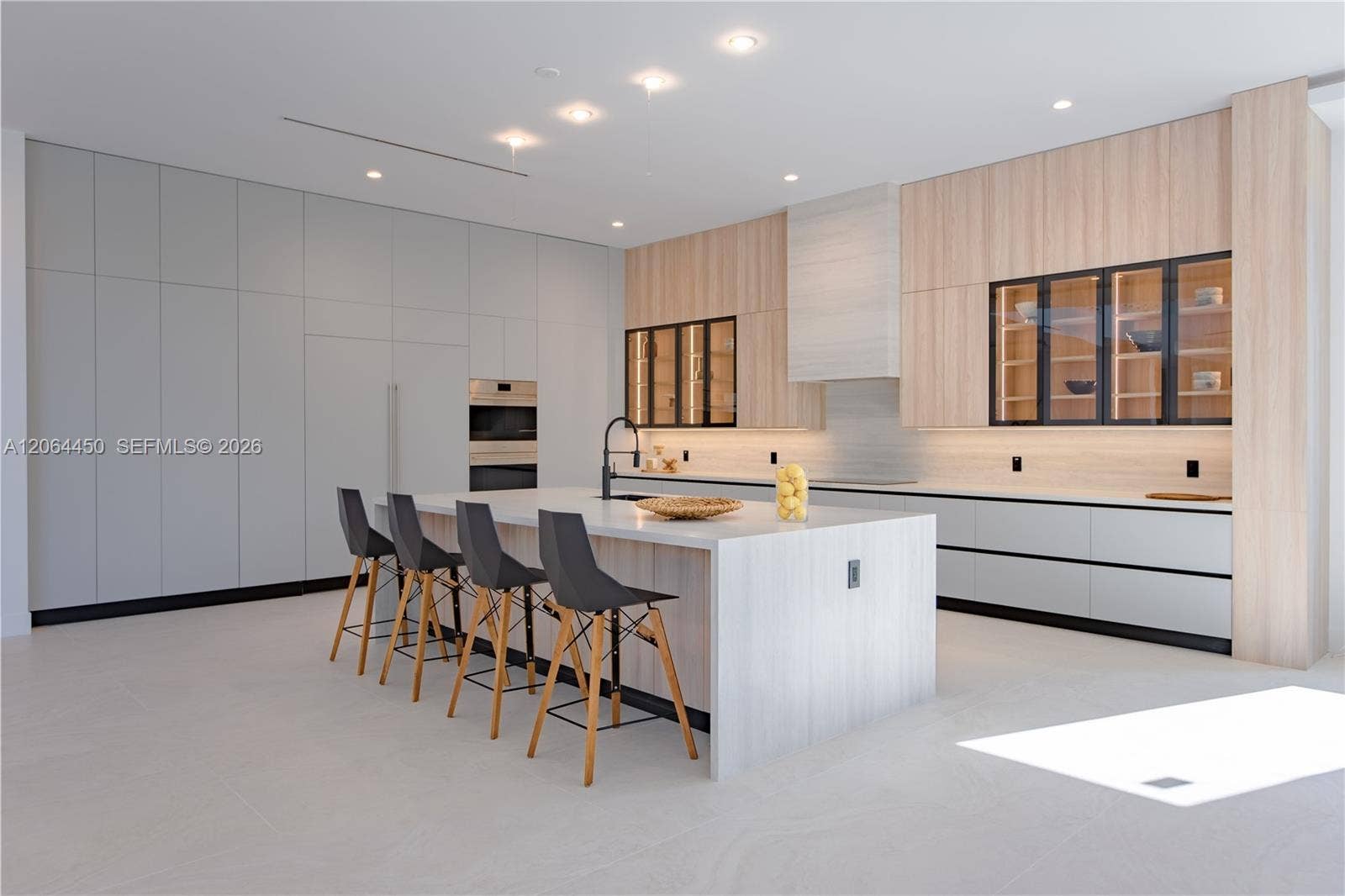 Sleek kitchen with built in appliances, quartz surfaces, and ample storage