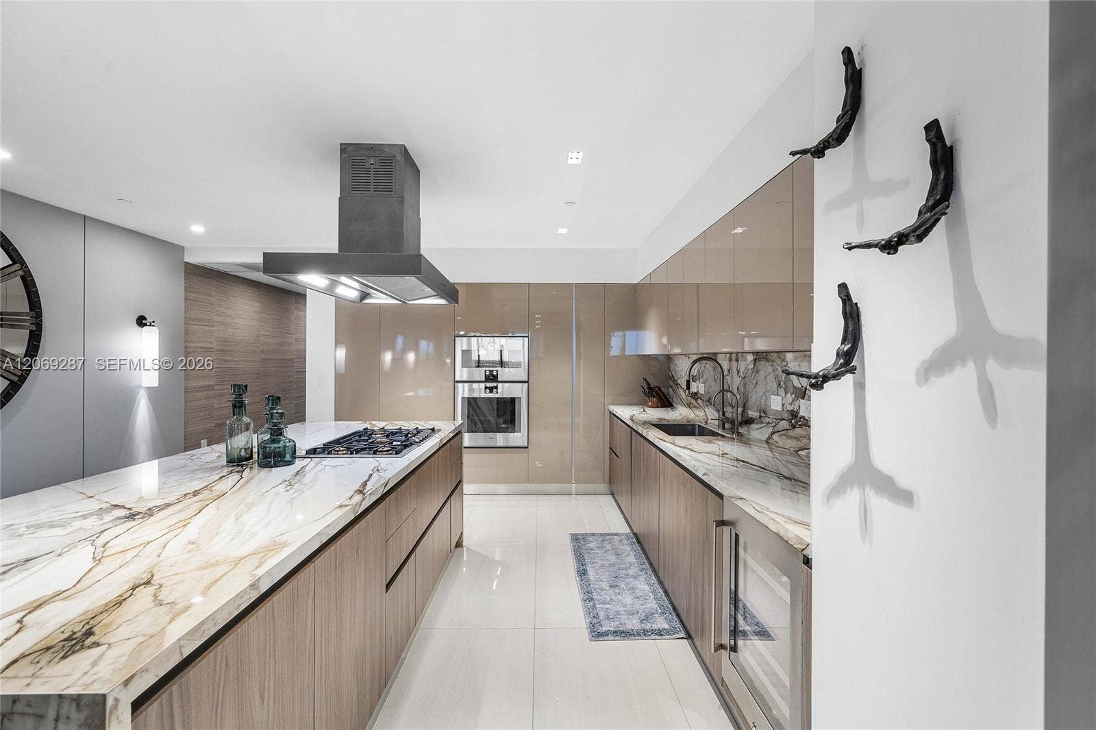 435 Bayshore Drive, #703, Fort Lauderdale, FL 33304 A sophisticated Italian-designed kitchen featuring custom cabinetry, premium Gaggenau appliances, gas cooking and an elegant island ideal for entertaining.