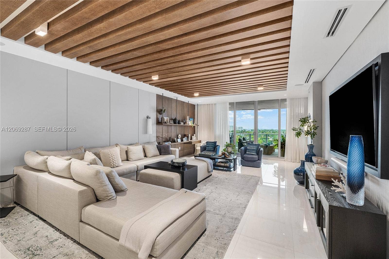 435 Bayshore Drive, #703, Fort Lauderdale, FL 33304 An expansive living room offering panoramic waterfront views and seamless access to the terrace.