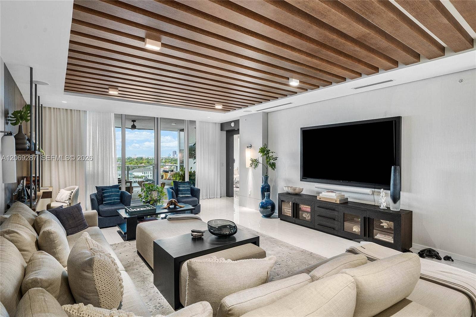 435 Bayshore Drive, #703, Fort Lauderdale, FL 33304 An expansive living room offering panoramic waterfront views and seamless access to the terrace.