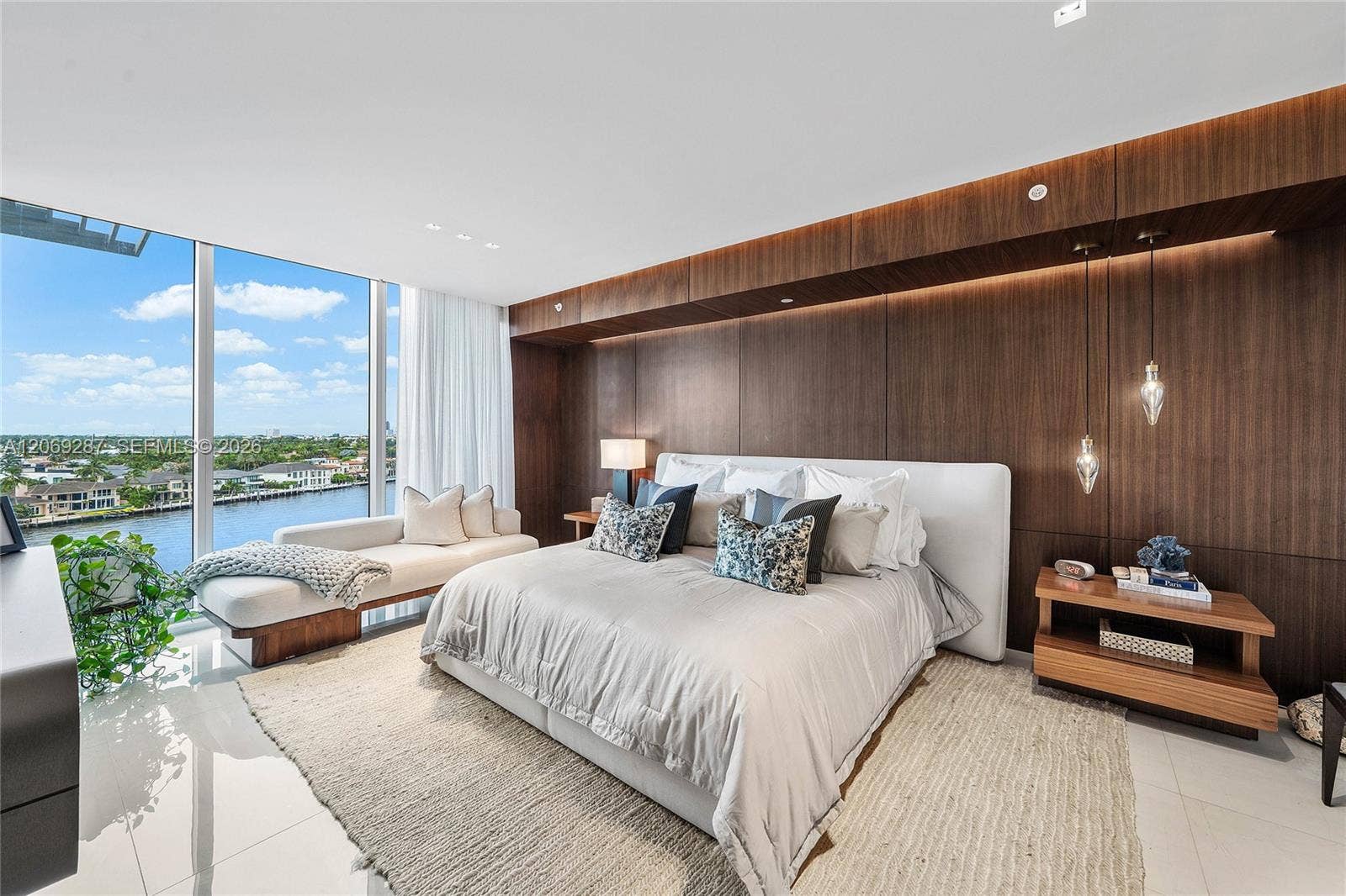435 Bayshore Drive, #703, Fort Lauderdale, FL 33304 A serene primary suite with floor-to-ceiling glass, private terrace access and captivating waterfront views.