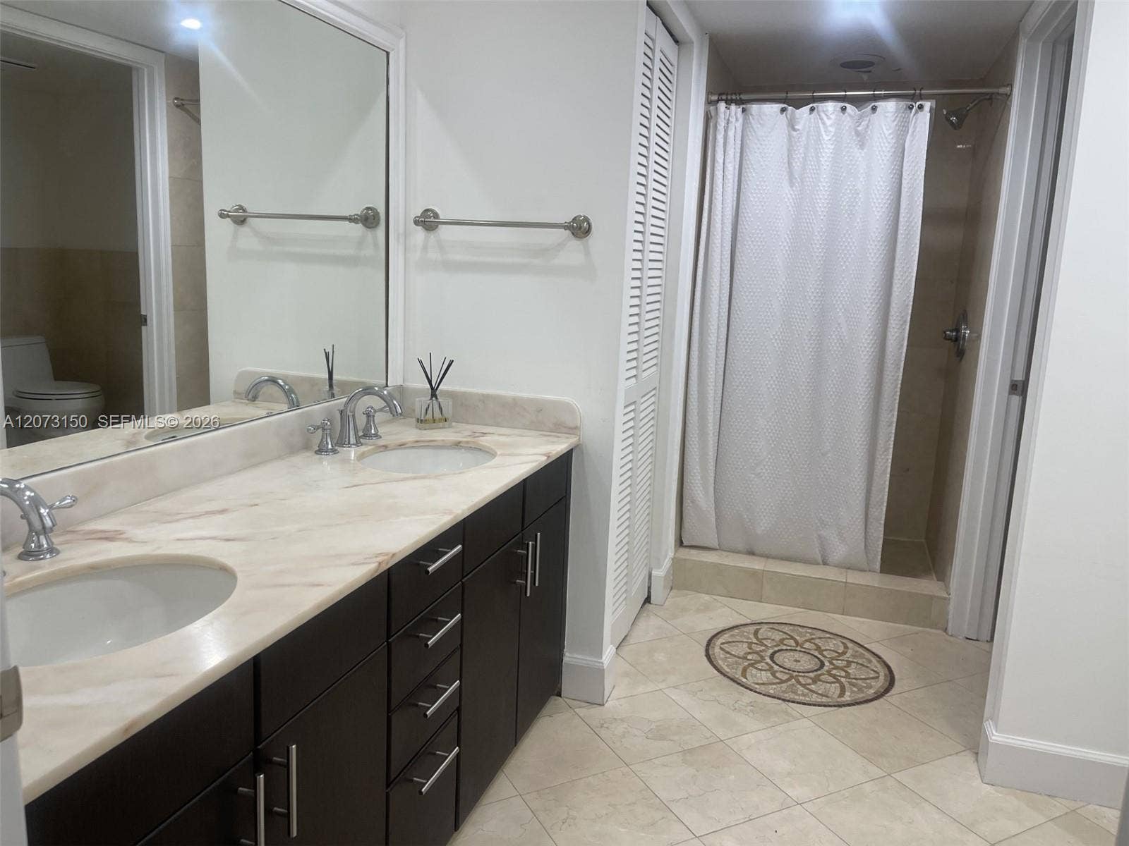 141 Crandon Boulevard, #243, Key Biscayne, Key Biscayne, FL 33149 Bathroom featuring a dark wood vanity with dual under-mount sinks, a stone countertop, oversized wall mirror, and a walk-in shower with tile flooring