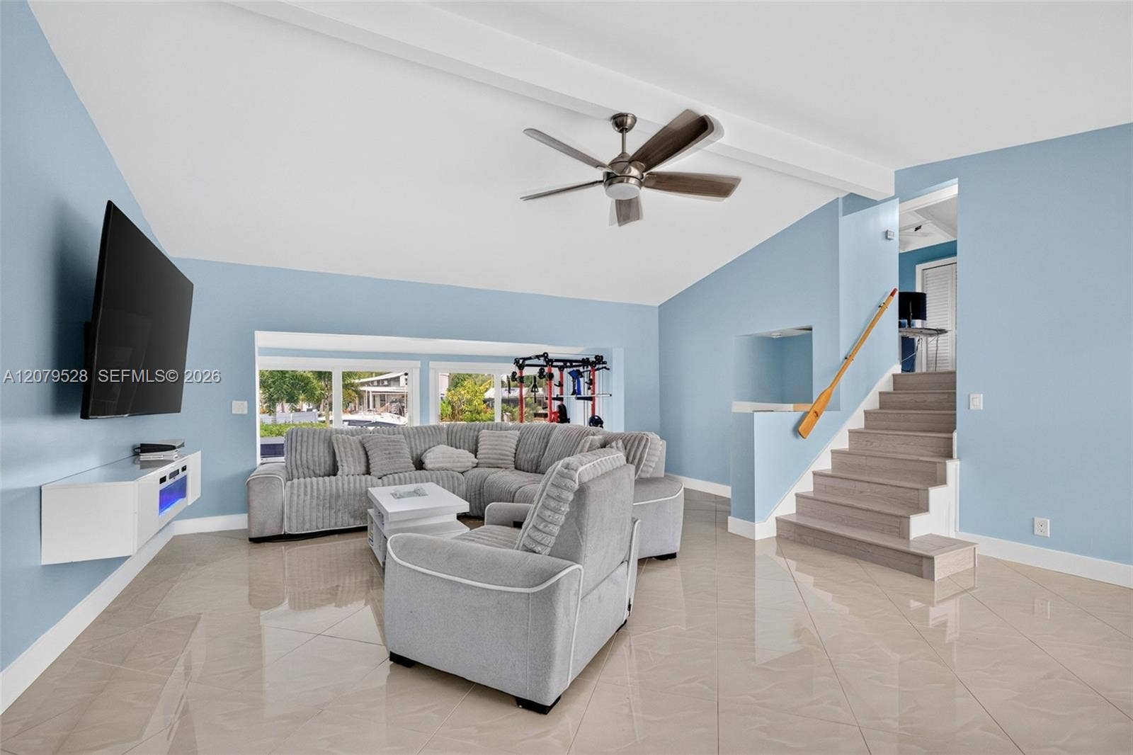 2518 Tortugas Lane, Fort Lauderdale, FL 33312 Living rm on main level. Primary bedroom to left. stairs up and down to the right. Volume beamed ceilings, impact windows, plantation shutters