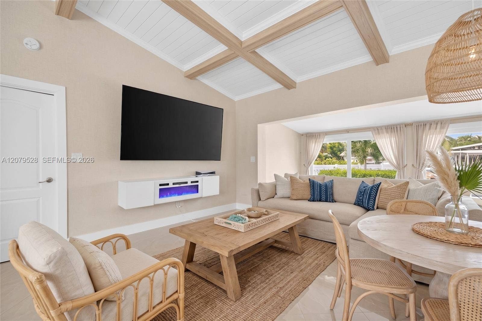 2518 Tortugas Lane, Fort Lauderdale, FL 33312 Living rm on main level. Primary bedroom to left. stairs up and down to the right. Volume beamed ceilings, impact windows, plantation shutters. Virtually Staged.
