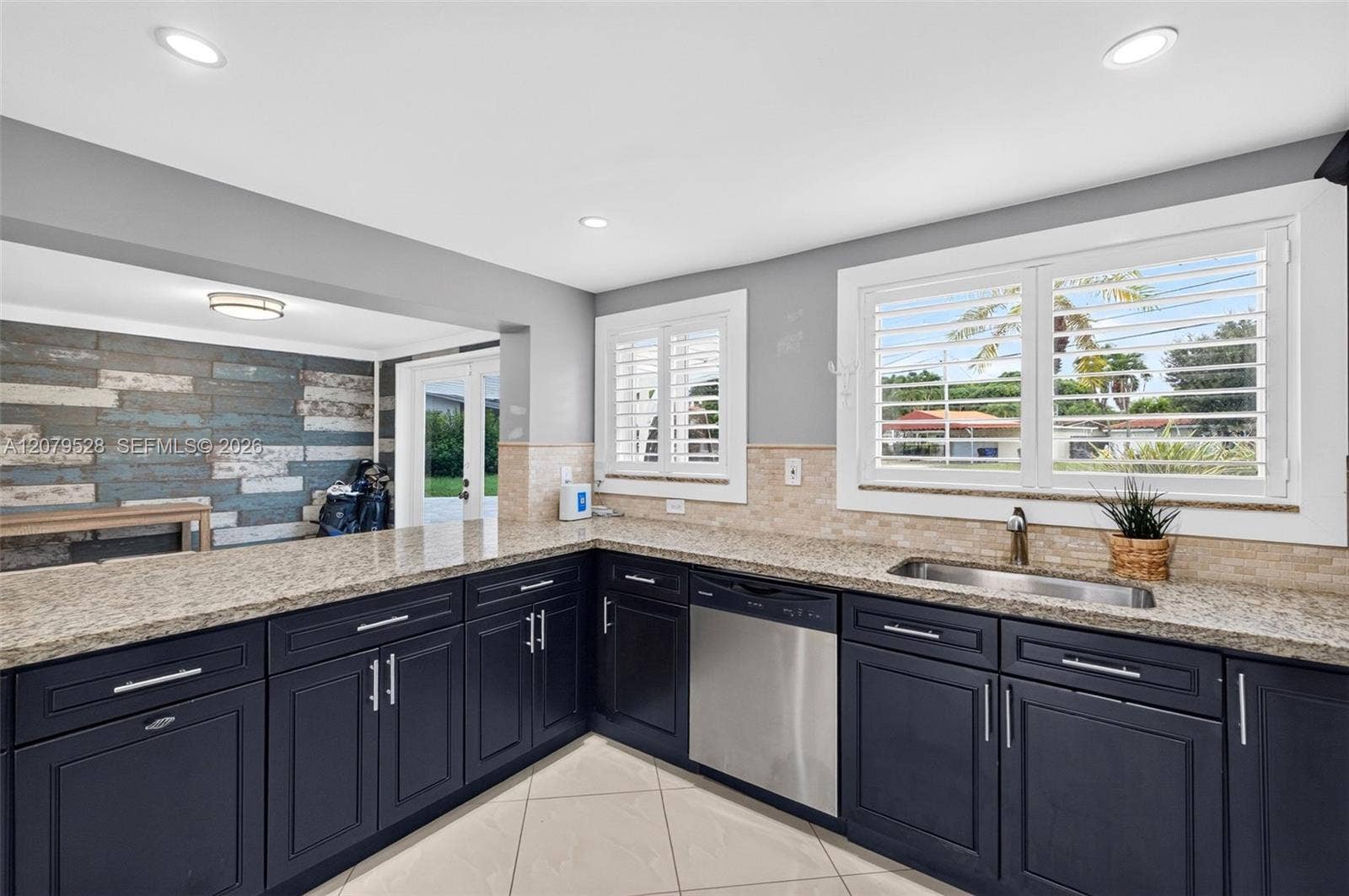 2518 Tortugas Lane, Fort Lauderdale, FL 33312 Large bright kitchen w/ windows everywhere, plantation shutters, wood cabinets, stainless appliances and granite counters