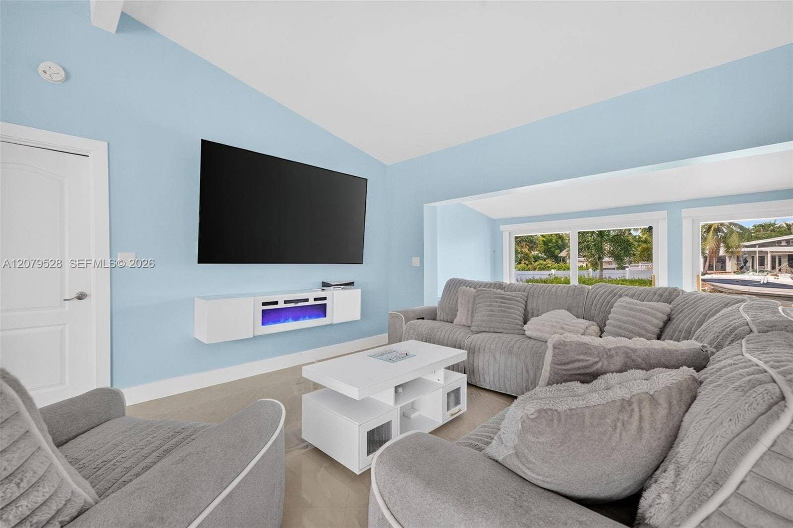2518 Tortugas Lane, Fort Lauderdale, FL 33312 Living rm on main level. Primary bedroom to left. stairs up and down to the right. Volume beamed ceilings, impact windows, plantation shutters