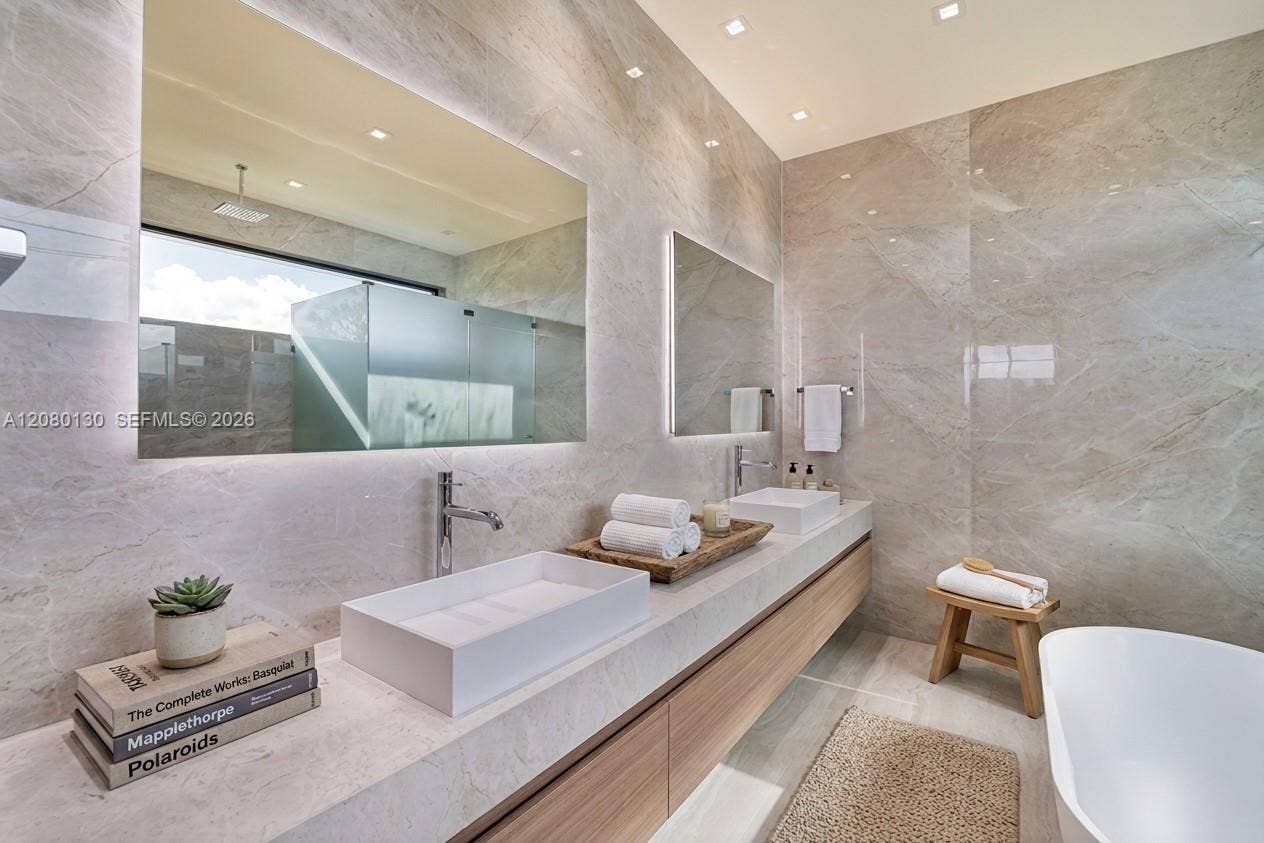 Primary Bathroom. Disclaimer: Several photographs presented in this listing contain digitally added furniture, artwork, and decor. These virtually staged images are intended solely for illustrative purposes.