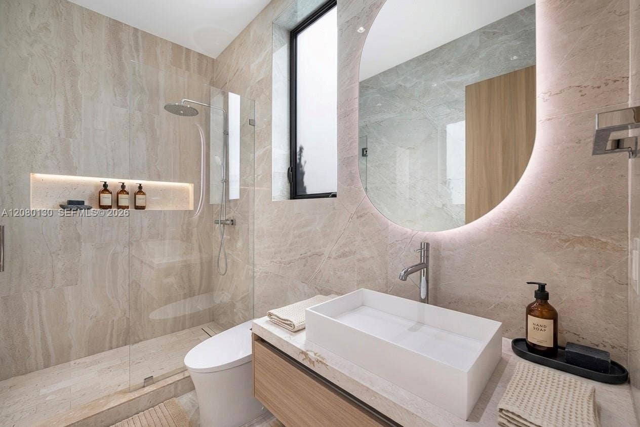 Guest Bathroom. Disclaimer: Several photographs presented in this listing contain digitally added furniture, artwork, and decor. These virtually staged images are intended solely for illustrative purposes.