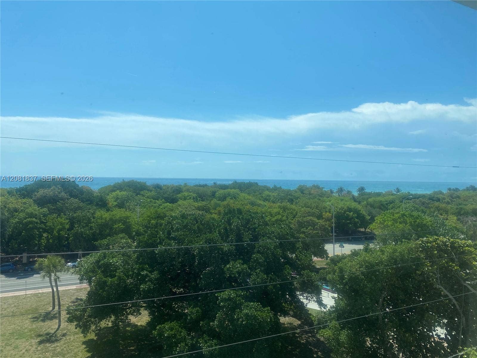 8233 Harding Avenue, #707, Miami Beach, Miami Beach, FL 33141 Elevated perspective featuring ocean water, dense foliage, and open sky