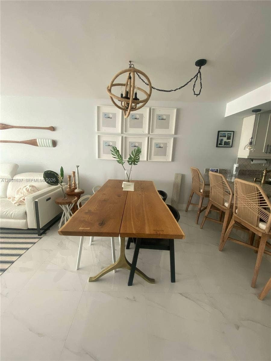 8233 Harding Avenue, #707, Miami Beach, Miami Beach, FL 33141 Large-format tile flooring, sphere-style chandelier with natural rope detailing, and neutral interior finishes