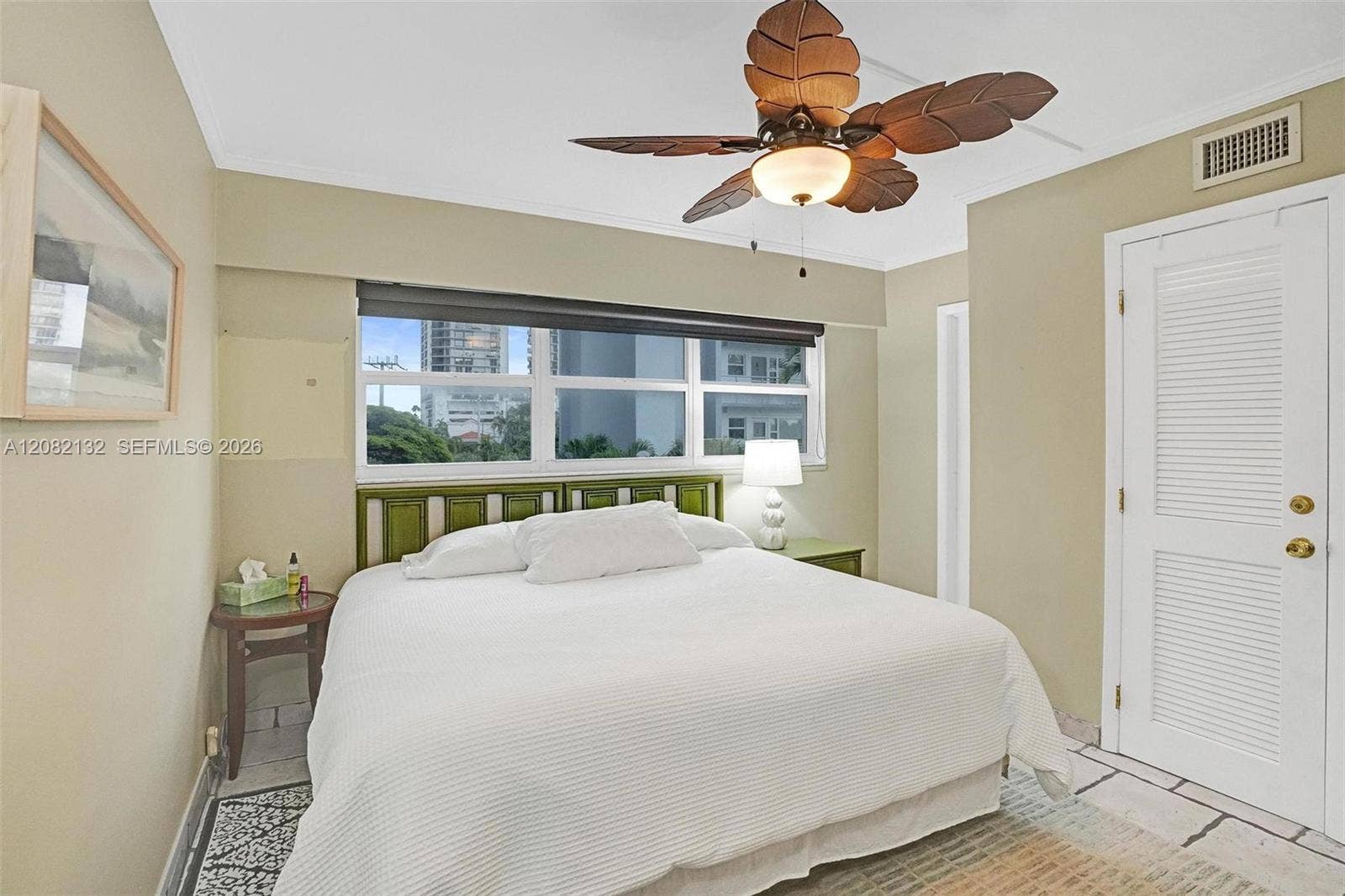 A light bright bedroom with remote controal ceiling fan