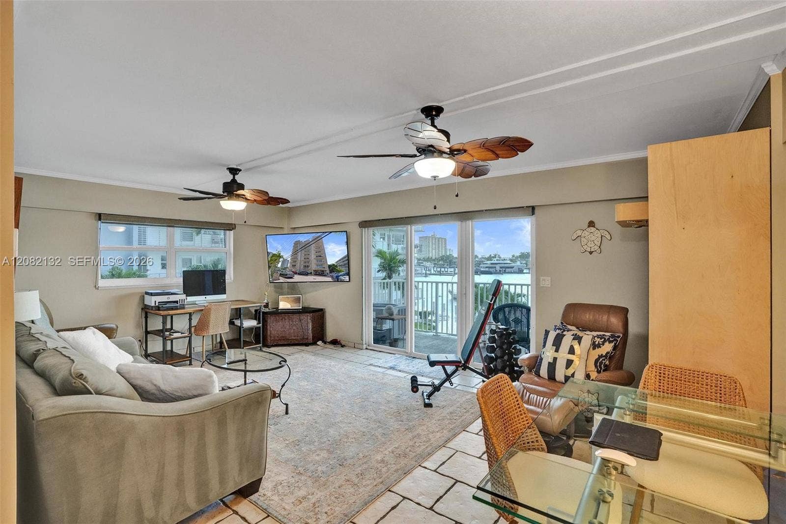 Sliding glass doors lead to Intracoastal-front balcony & those extra wrap-around windows keep this condo