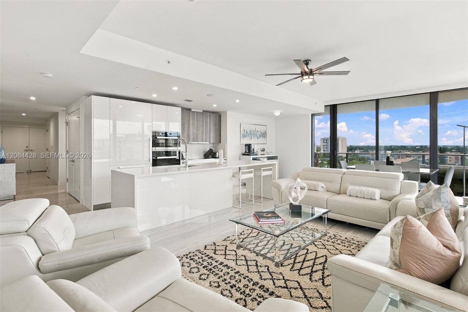 730 N Ocean Boulevard, #601, Pompano Beach, Pompano Beach, FL 33062 Spacious open-concept living room and kitchen with floor-to-ceiling glass.
